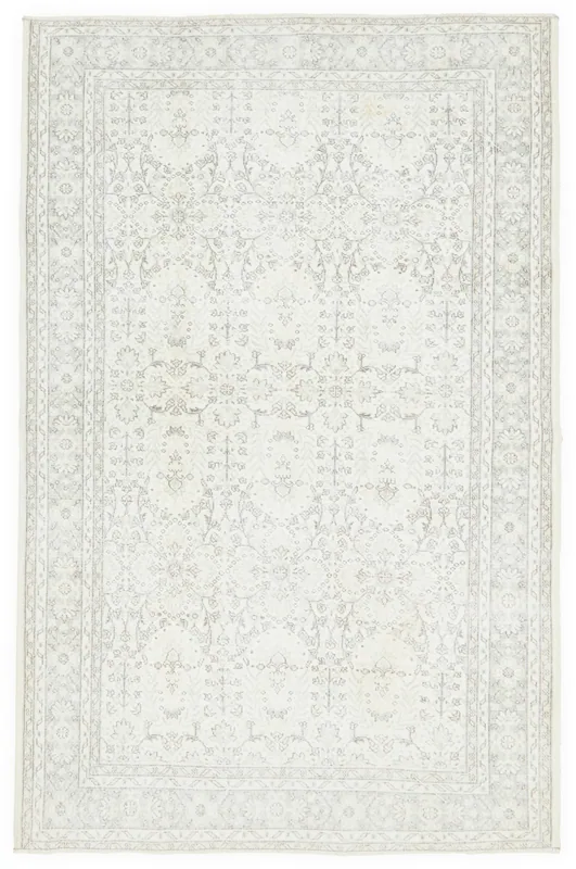 Full overhead view of the 6'6" x 10'0" ivory floral Anatolian rug on a white background