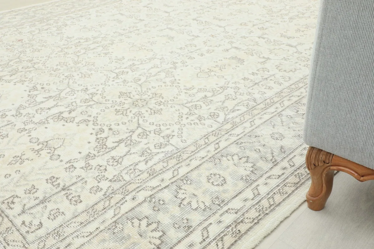 View of the rug extending under a sofa, showing how it anchors the living room space