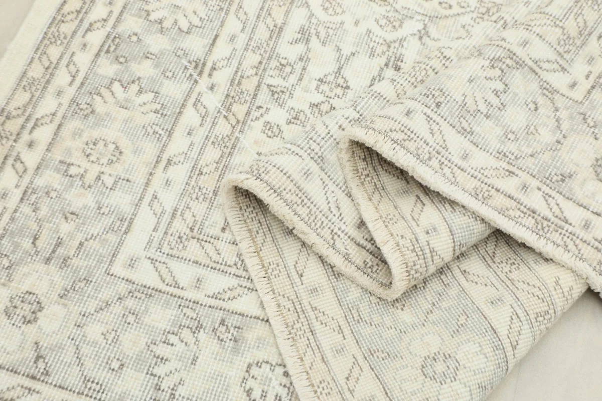 Close-up of the rug's low wool pile and the texture of the hand-knotted construction