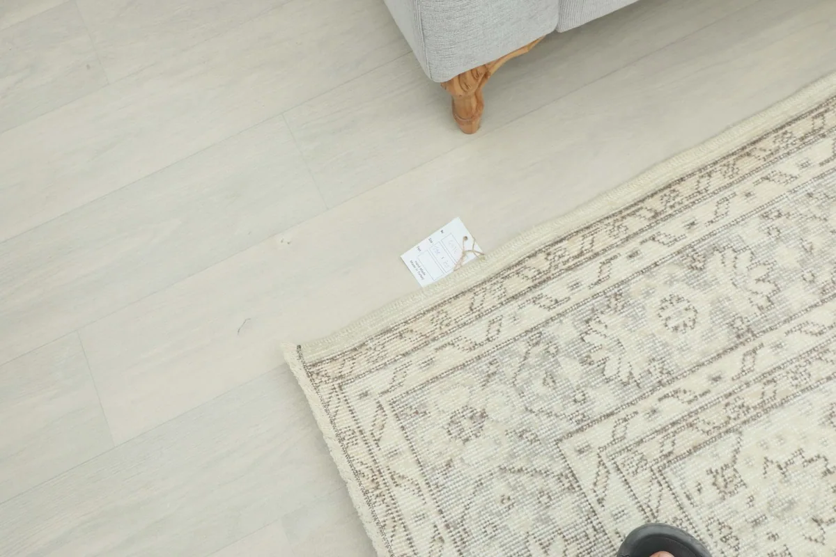Overhead perspective of the rug with a small tag visible on the light-colored floor