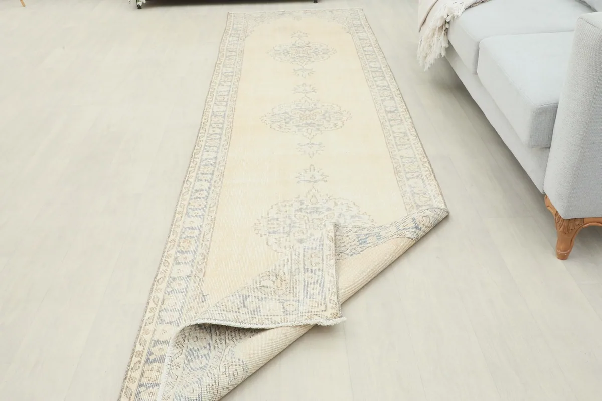 Runner rug with one end folded back, showing the full length and the reverse side.