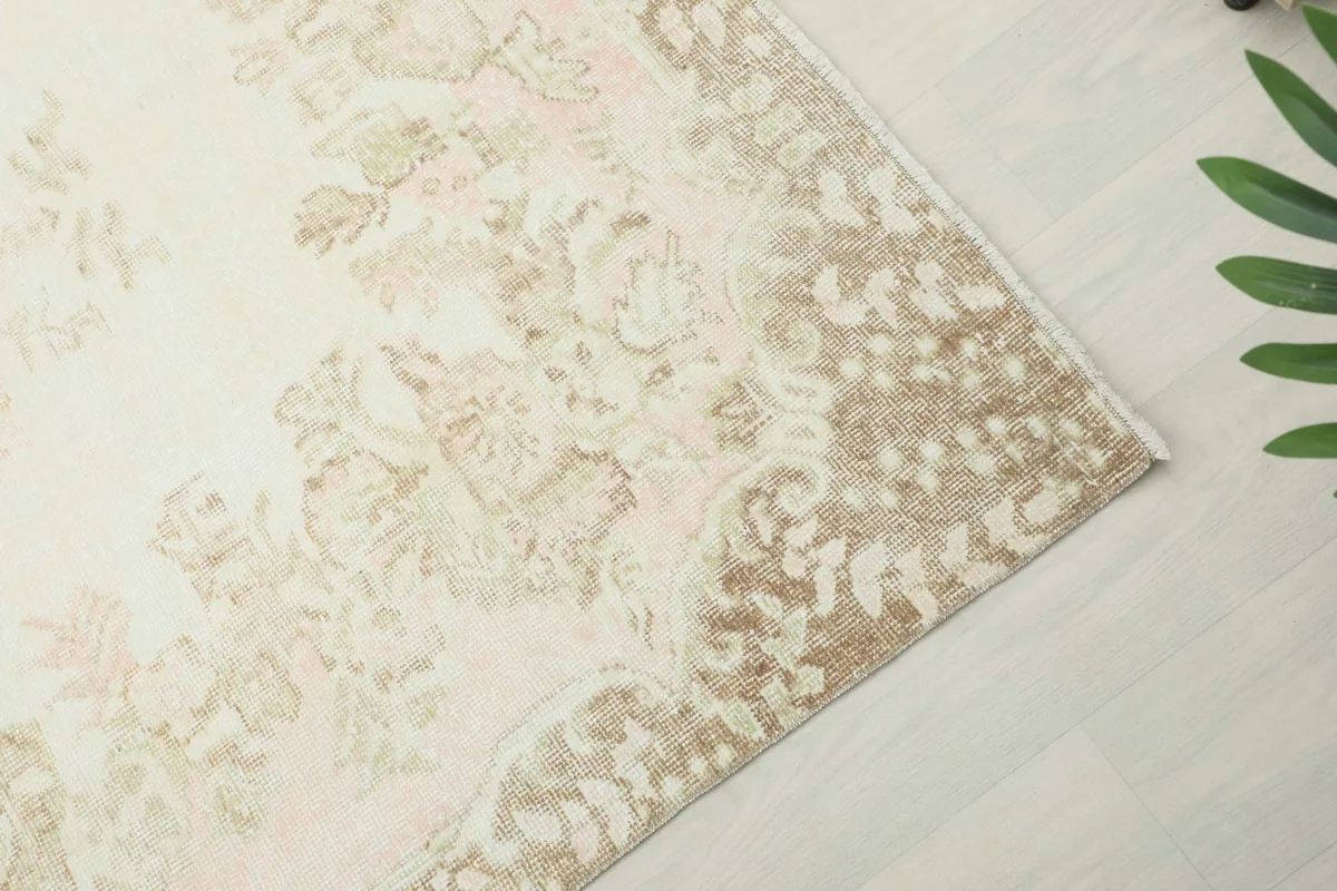 Angled view of the Soft Rose Floral Medallion Rug, showcasing the faded rose and ivory patterns.