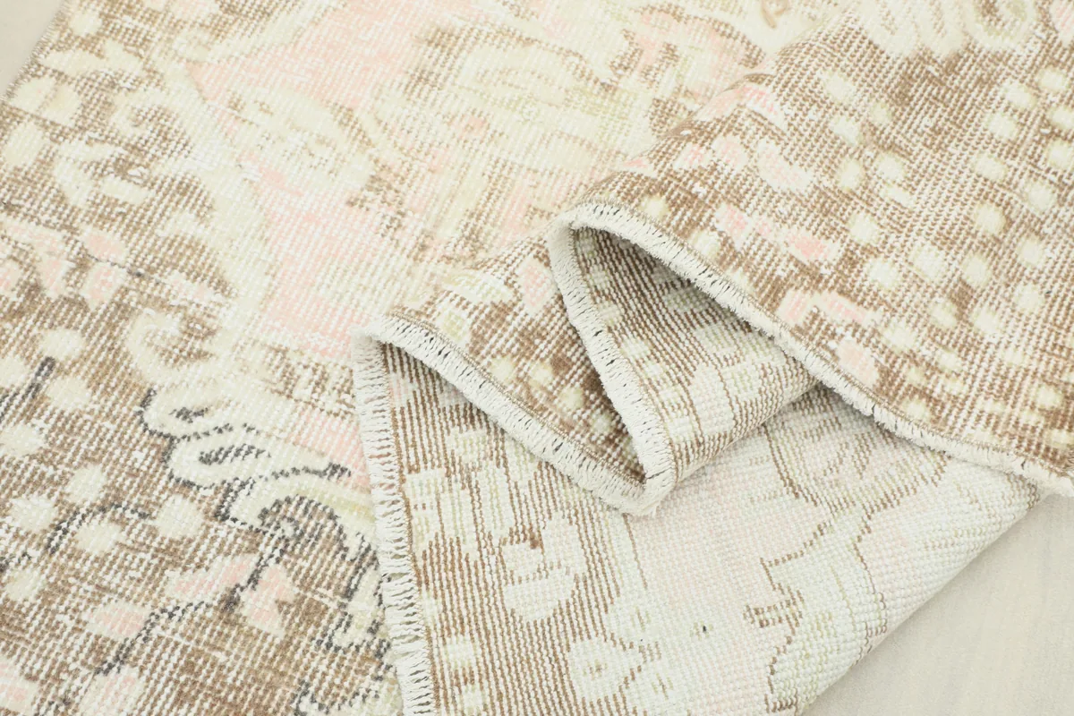 Close-up of the Soft Rose Floral Medallion Rug pile, showing the hand-knotted texture and faded colors.