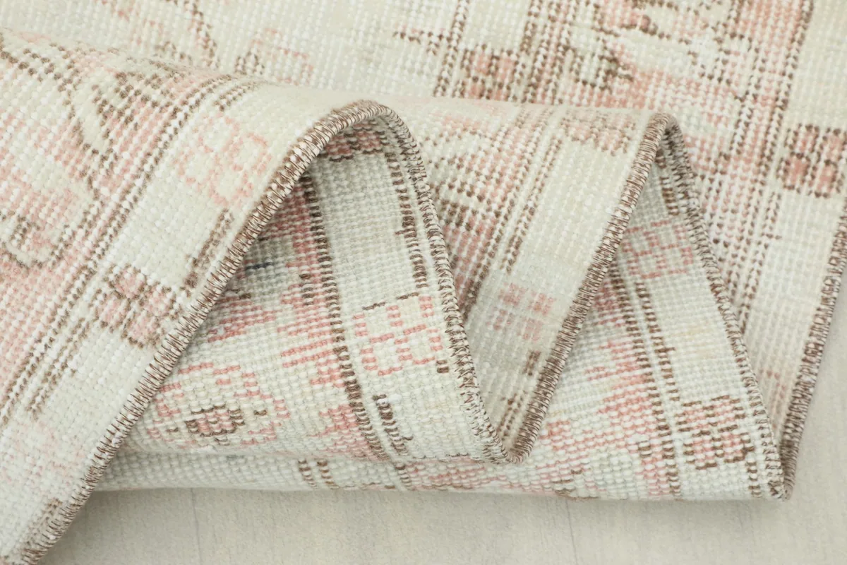 Close-up of the low wool pile and the intricate knotting visible when folded.