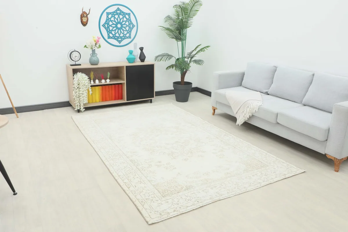 Ivory rug displayed in a bright room setting, showcasing its size and appearance with furniture.