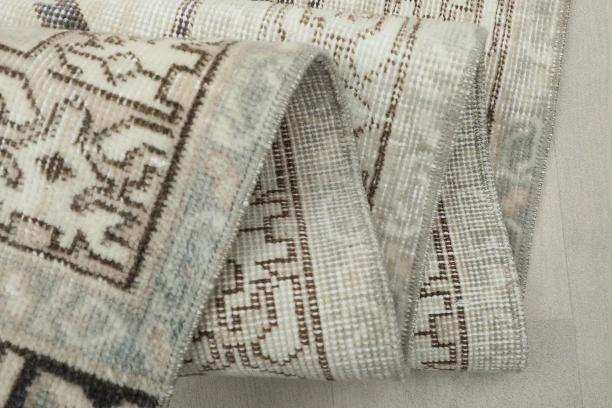 Close-up of the rug's folded edge, highlighting the weave and fringe