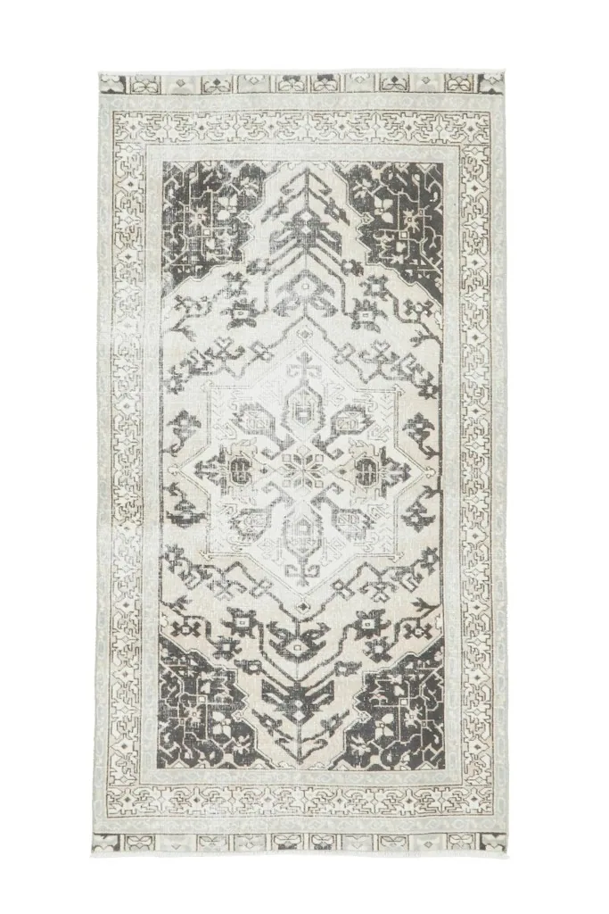 Full overhead view of the cream and charcoal rug, showing the entire design