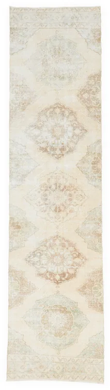 Full top view of the 2'11" x 12'2" ivory vintage Anatolian runner rug with geometric medallions.