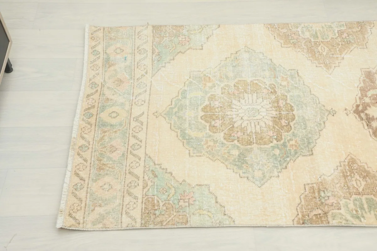 Close-up of the other end of the runner rug, highlighting the border and a geometric medallion.