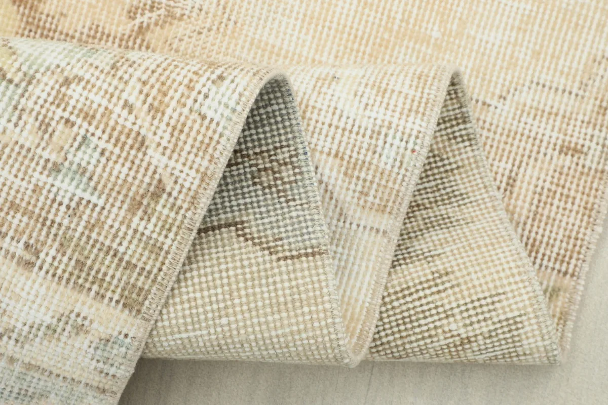 Folded section of the runner rug, revealing the texture of the hand-knotted wool pile.