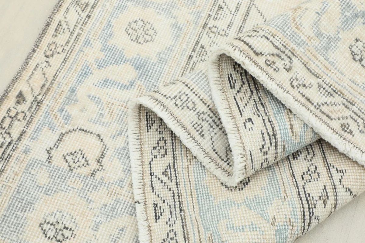 Closer view of the folded rug, emphasizing the texture and color variations in the pile.
