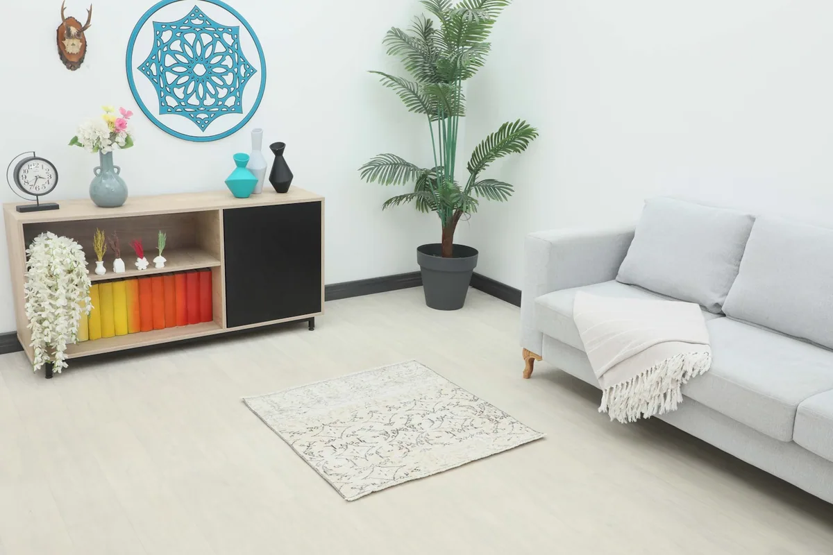Ivory and charcoal geometric vintage Anatolian rug placed in a modern living room setting.