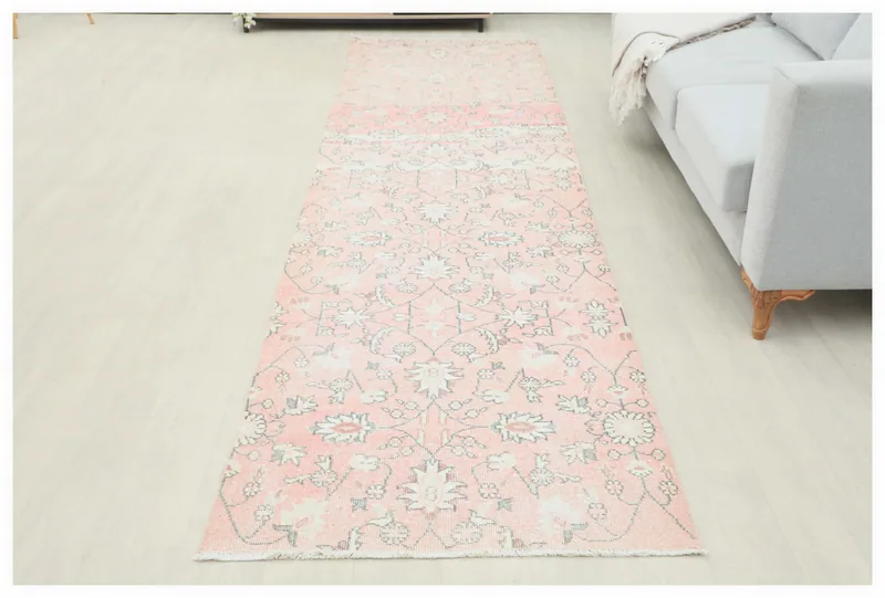 Full top view of the 3'3" x 12'0" rose floral Anatolian runner rug on a white background.