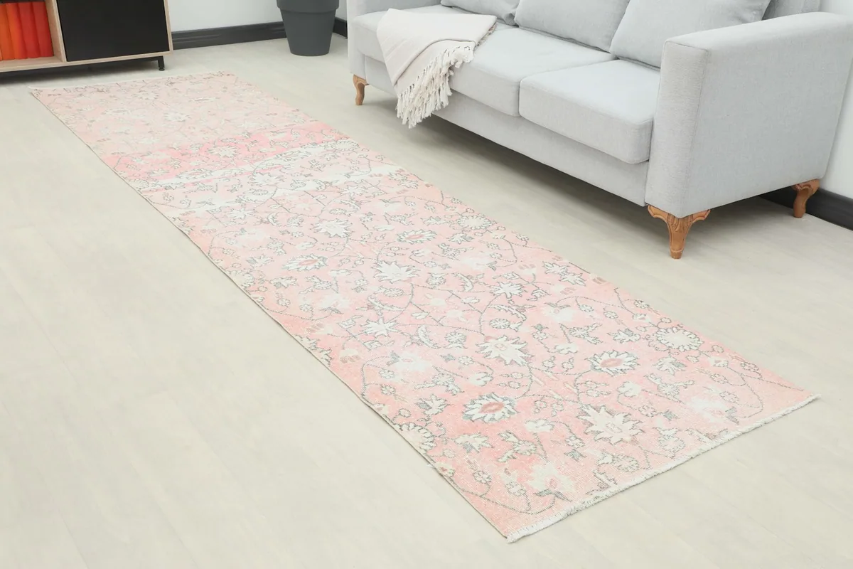Angle view of the rose runner rug in a living space, highlighting the floral and geometric patterns.