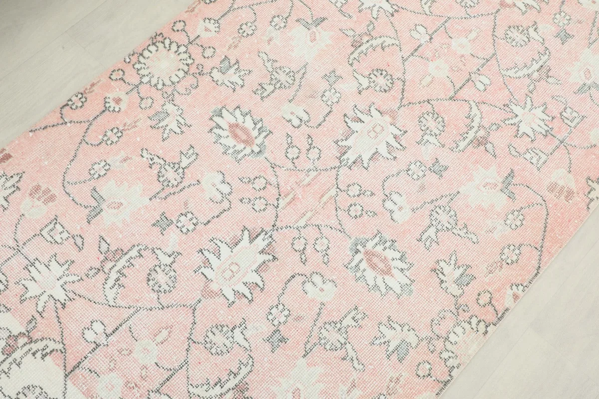 Detailed view of the intricate floral designs and subtle color shifts across the runner.