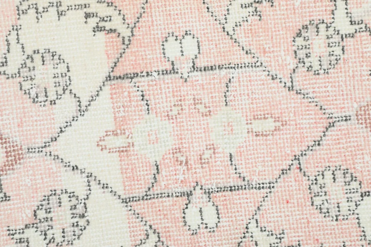 Close-up of the hand-knotted wool pile, revealing the texture and low height of the rug.