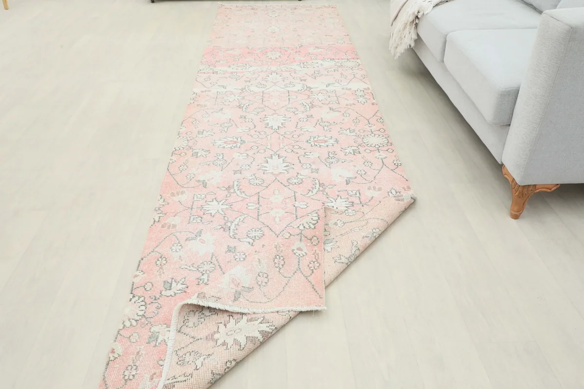 Runner rug partially folded, demonstrating its flexibility and construction.