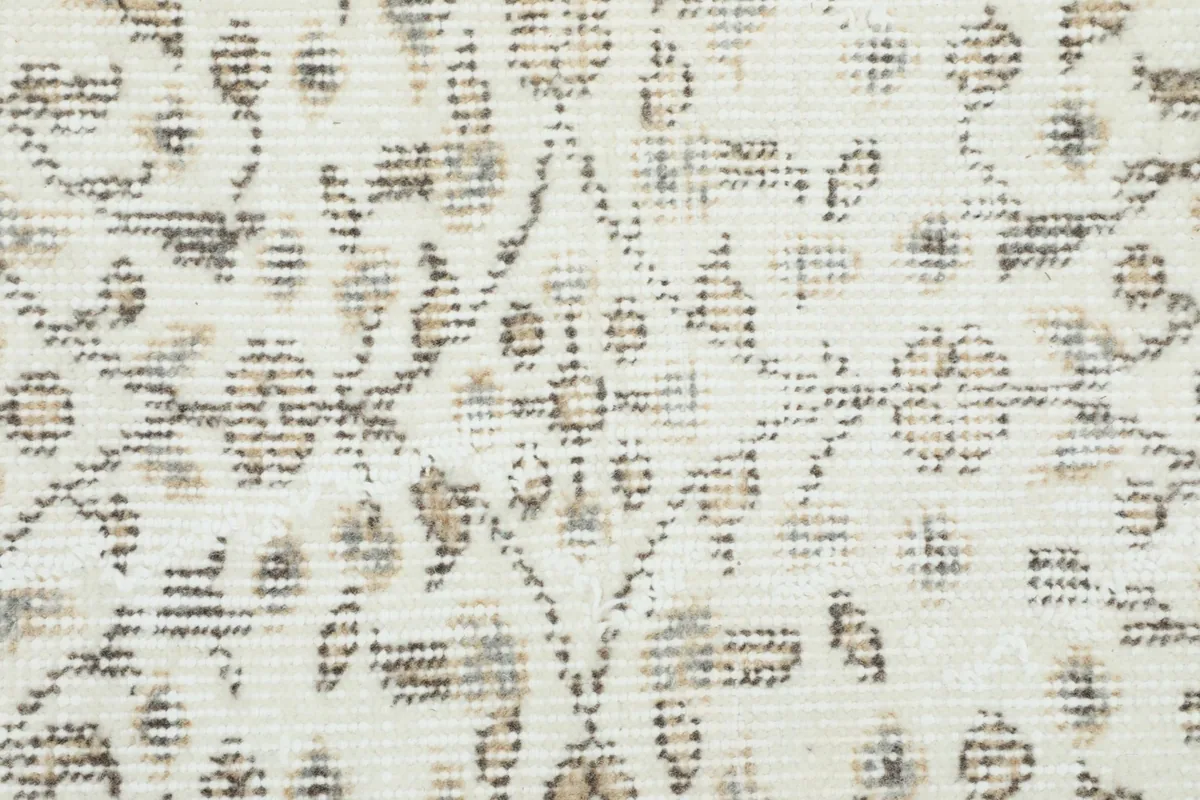 Close-up showing the low wool pile and hand-knotted texture of the rug