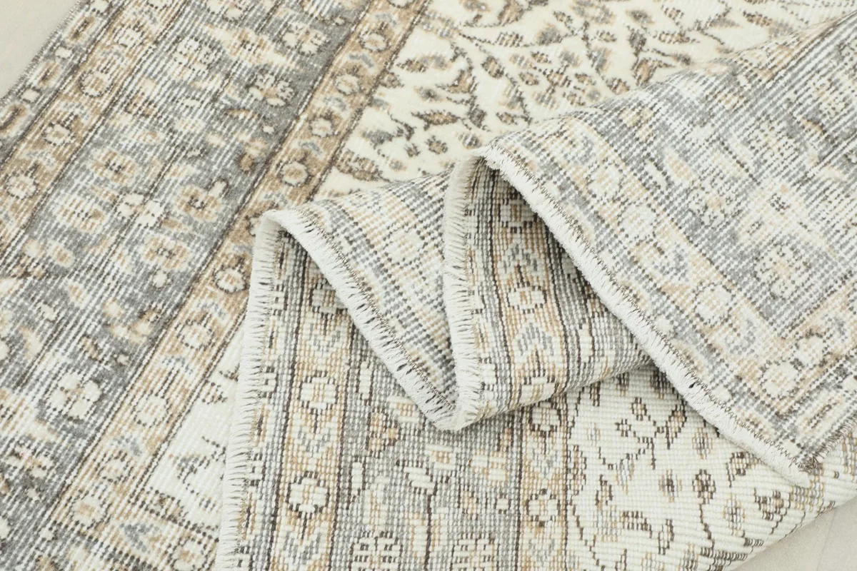 Folded section of the rug showing the thickness and the intricate back weaving