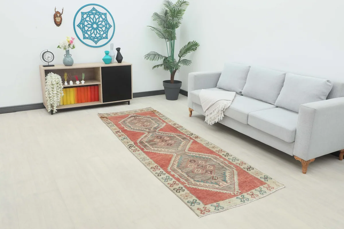The rust and gray runner displayed in a modern living space, showing its scale and color.