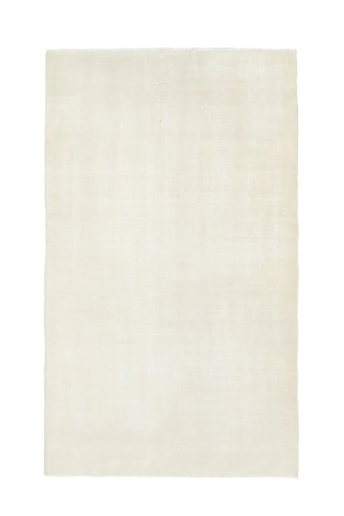 Full overhead view of the 3'7" x 6'2" ivory vintage Anatolian wool rug on a white background.