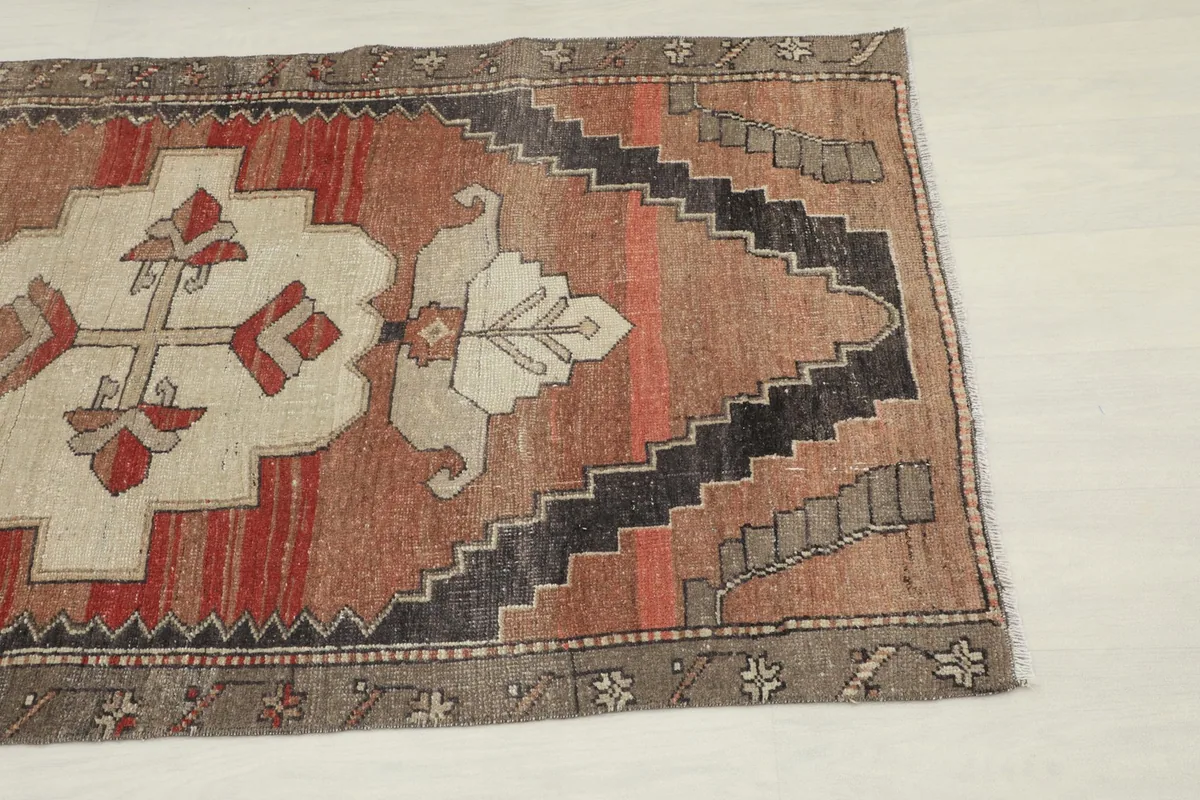 Close-up view of the central medallion and rust field, highlighting the hand-knotted texture.