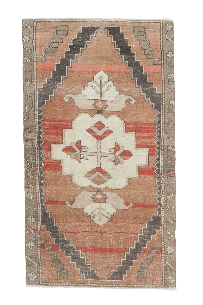 Full overhead view of the 3x6 rust and red vintage Anatolian rug on a white background.