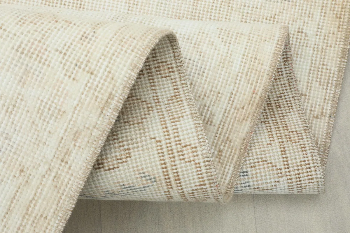 Detailed view of the back of the rug, showing the intricate hand-knotted wool on cotton foundation.