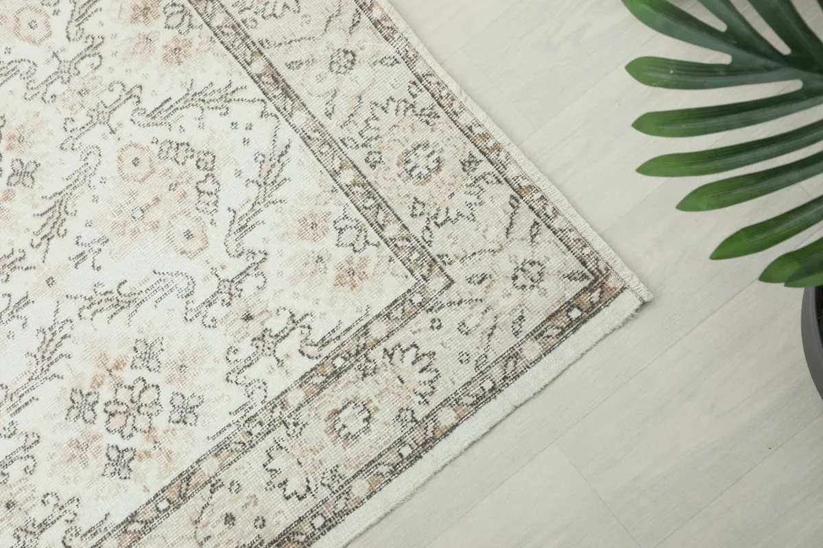 Corner view of the rug, showing the intricate border design and the main field