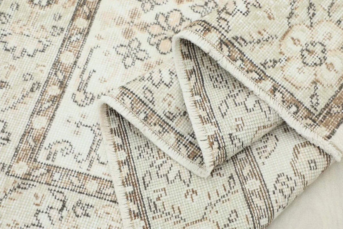 Rug folded to display the thickness of the wool pile and the detailed patterns