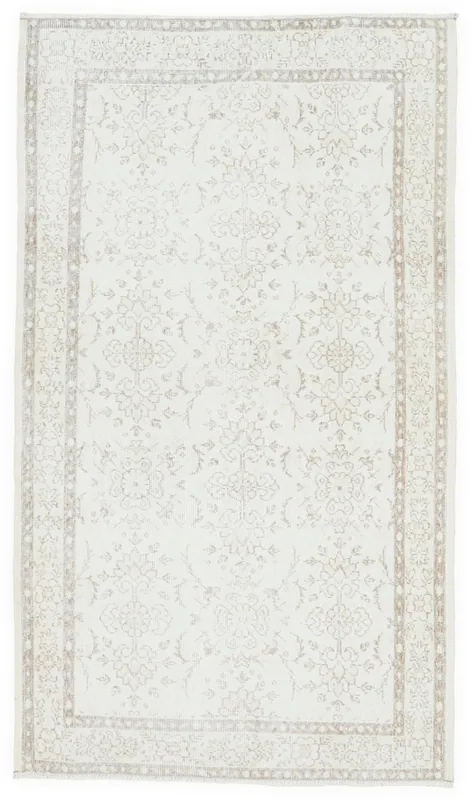Full overhead view of the 4x7 ivory and tan vintage Anatolian rug on a white background