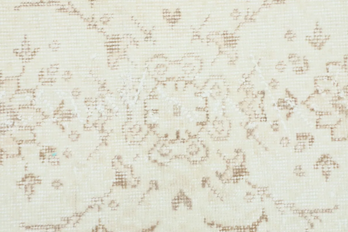 Detailed close-up of the central medallion design and surrounding floral patterns