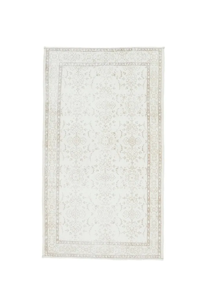 Full overhead view of the ivory and tan vintage Anatolian rug on a white background