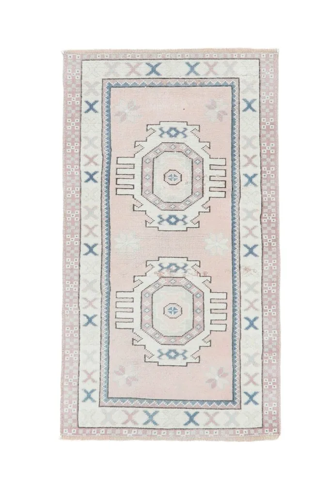 Full overhead view of the pink and ivory geometric medallion rug, isolated on white