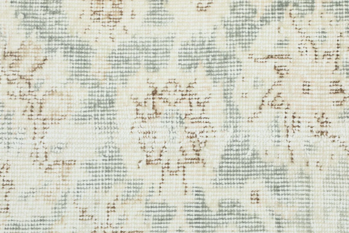 Textural close-up of the low wool pile, revealing the distressed appearance and interplay of colors.