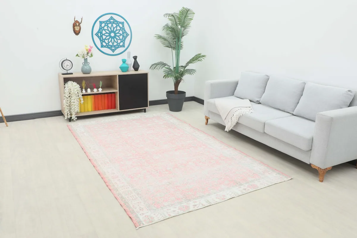 Vintage pink and ivory rug styled in a modern living room setting