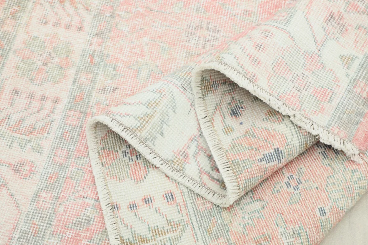 Multiple folds of the rug showing the thickness and texture of the hand-knotted wool