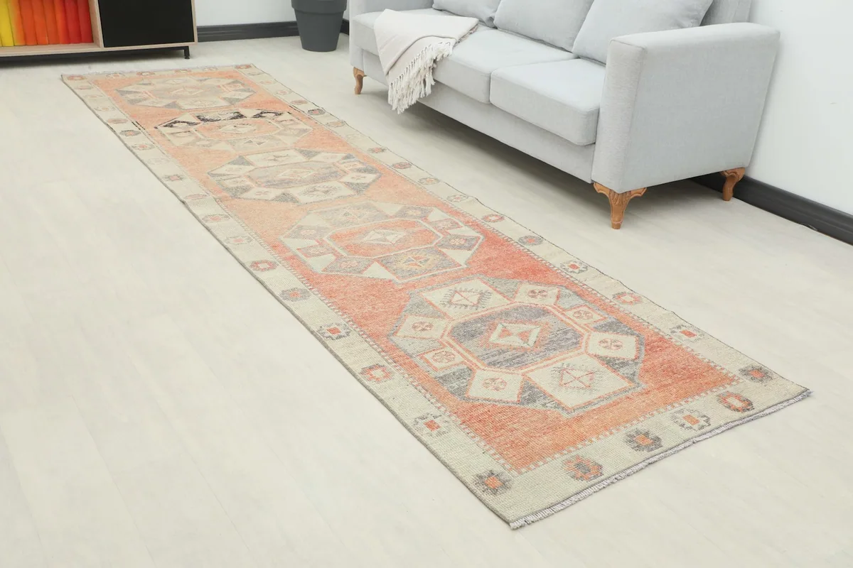 Full view of the rust and beige geometric runner in a modern room setting