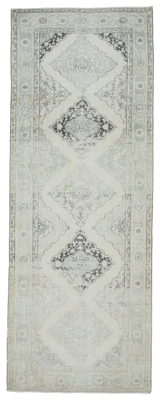Full top view of the 4'8" x 12'6" vintage Anatolian runner rug with cream and gray geometric patterns.