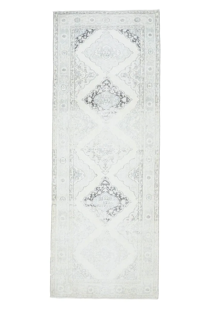 Full top view of the runner rug, emphasizing its elongated shape and balanced geometric design.