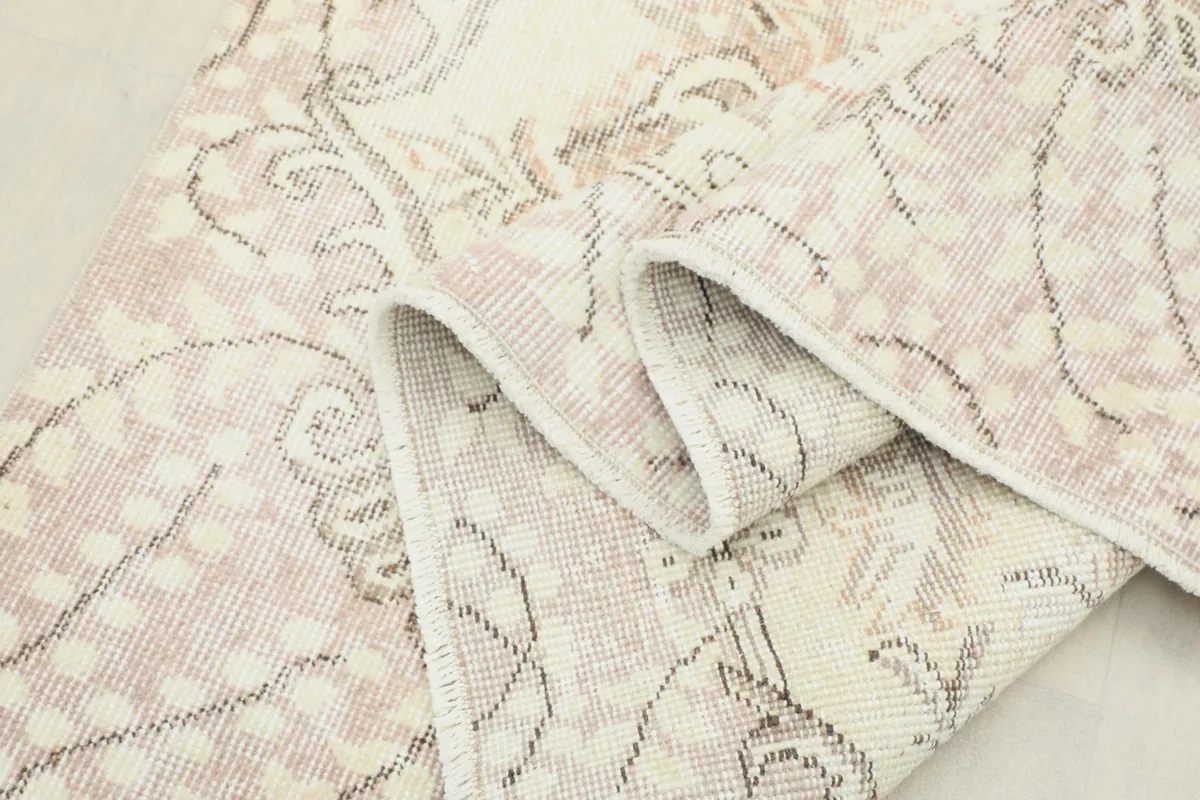 Close-up of the low wool pile and intricate hand-knotted texture, showing the vintage wear