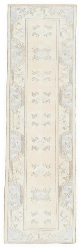 Full top view of the ivory and blue geometric Anatolian runner on a white background