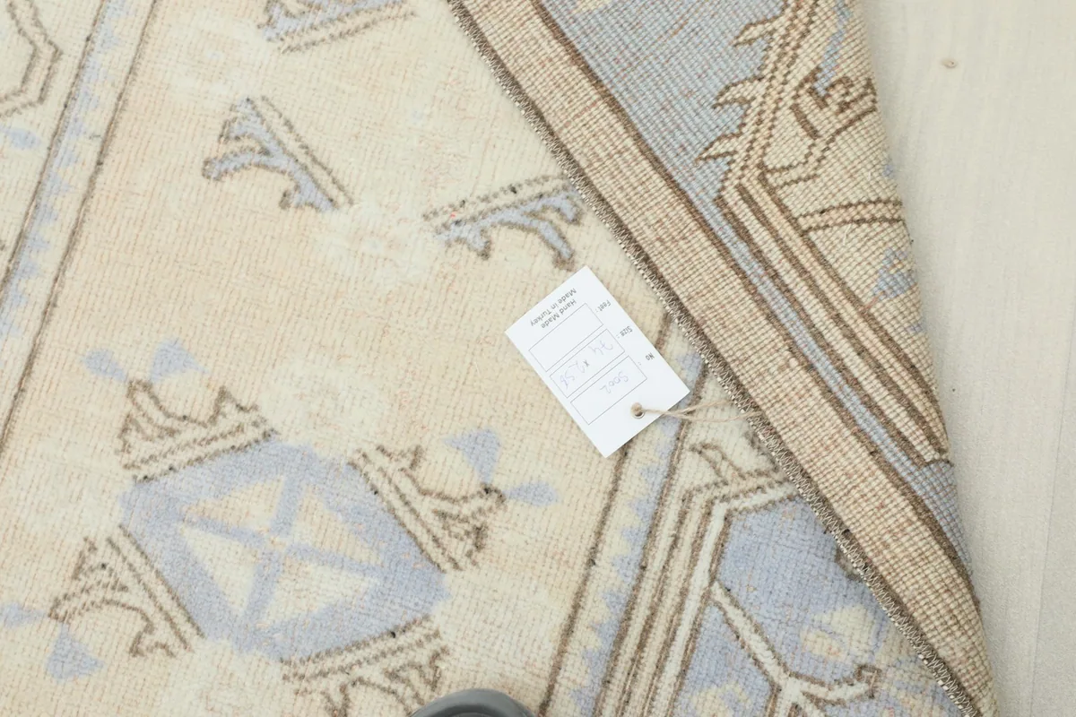 Detail showing a small tag on the rug, indicating its origin and material