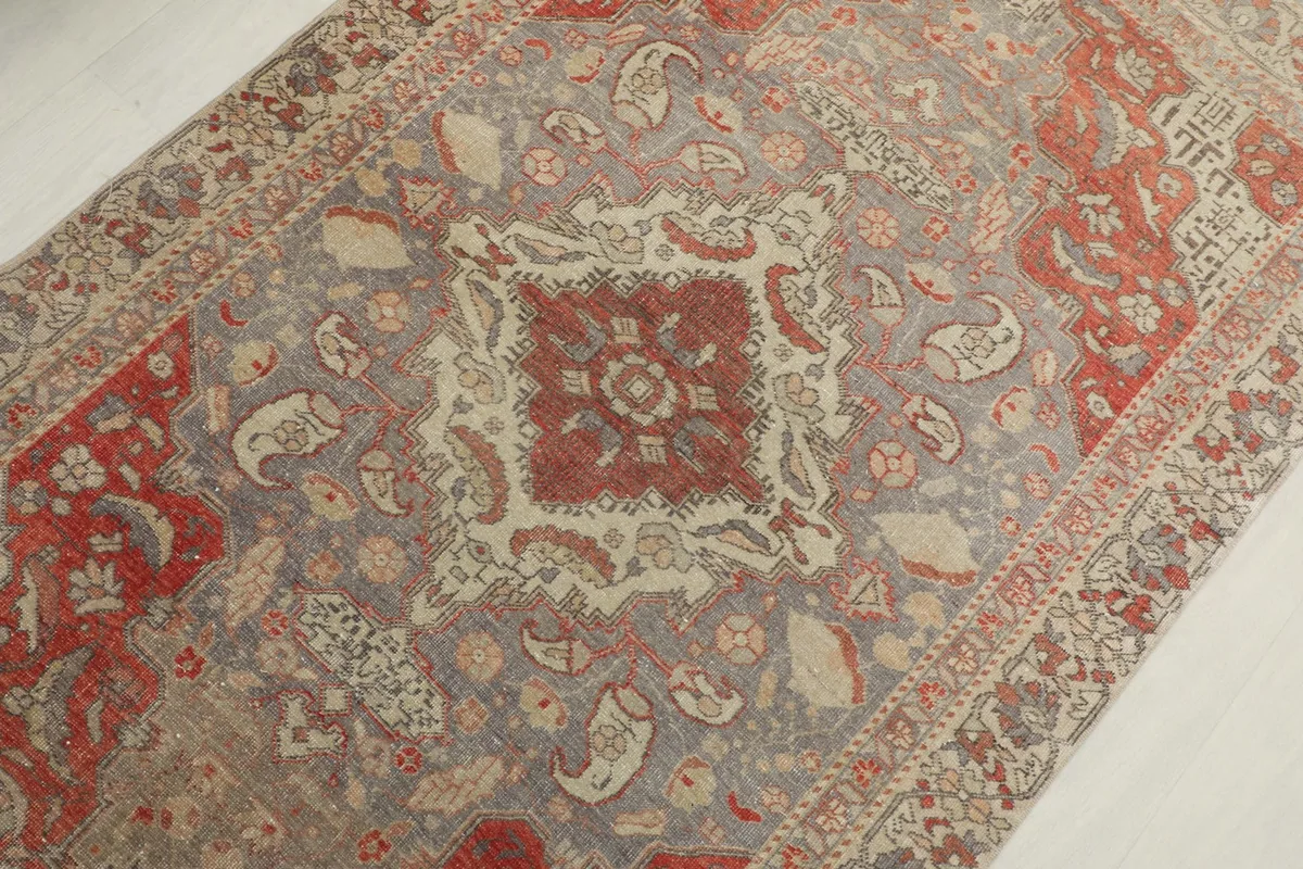 Detailed overhead view focusing on the central red and gray medallion and floral motifs.