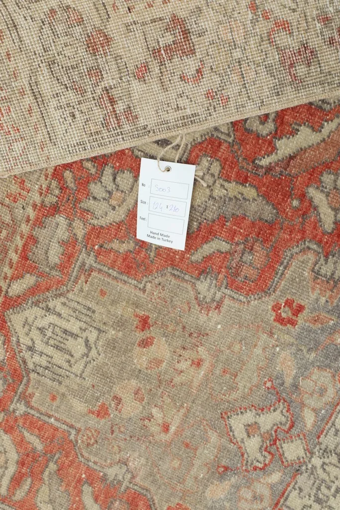 Detail of the rug's construction and texture, with a product tag visible.