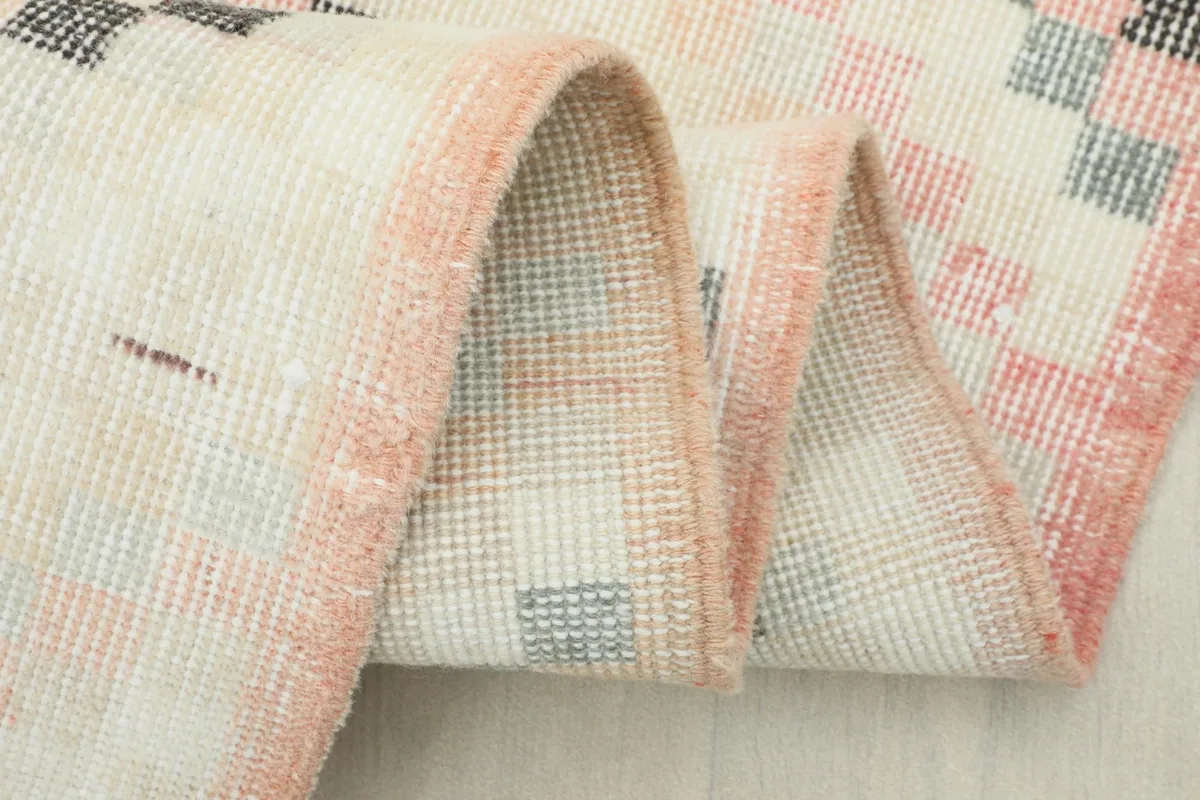 Close-up of the folded rug, highlighting the texture of the wool pile and the construction.
