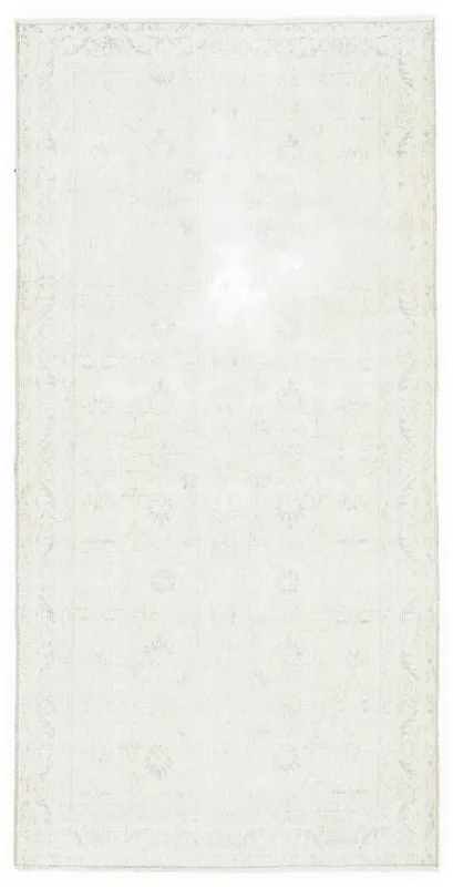 Full top view of the faded beige floral vintage Anatolian rug on a white background.