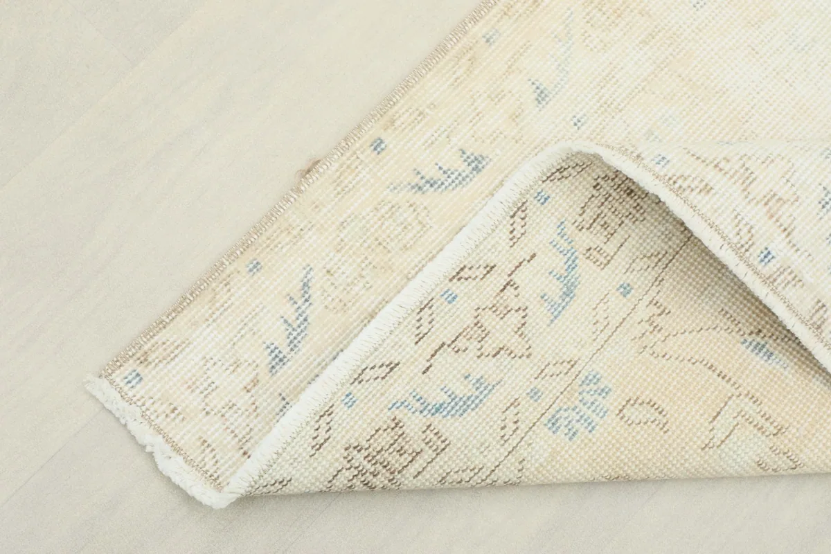 Underside view of the rug, showing the reverse of the hand-knotted construction and fringe.
