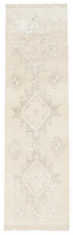 Full top view of the 2'11" x 10'6" ivory geometric vintage Anatolian runner rug