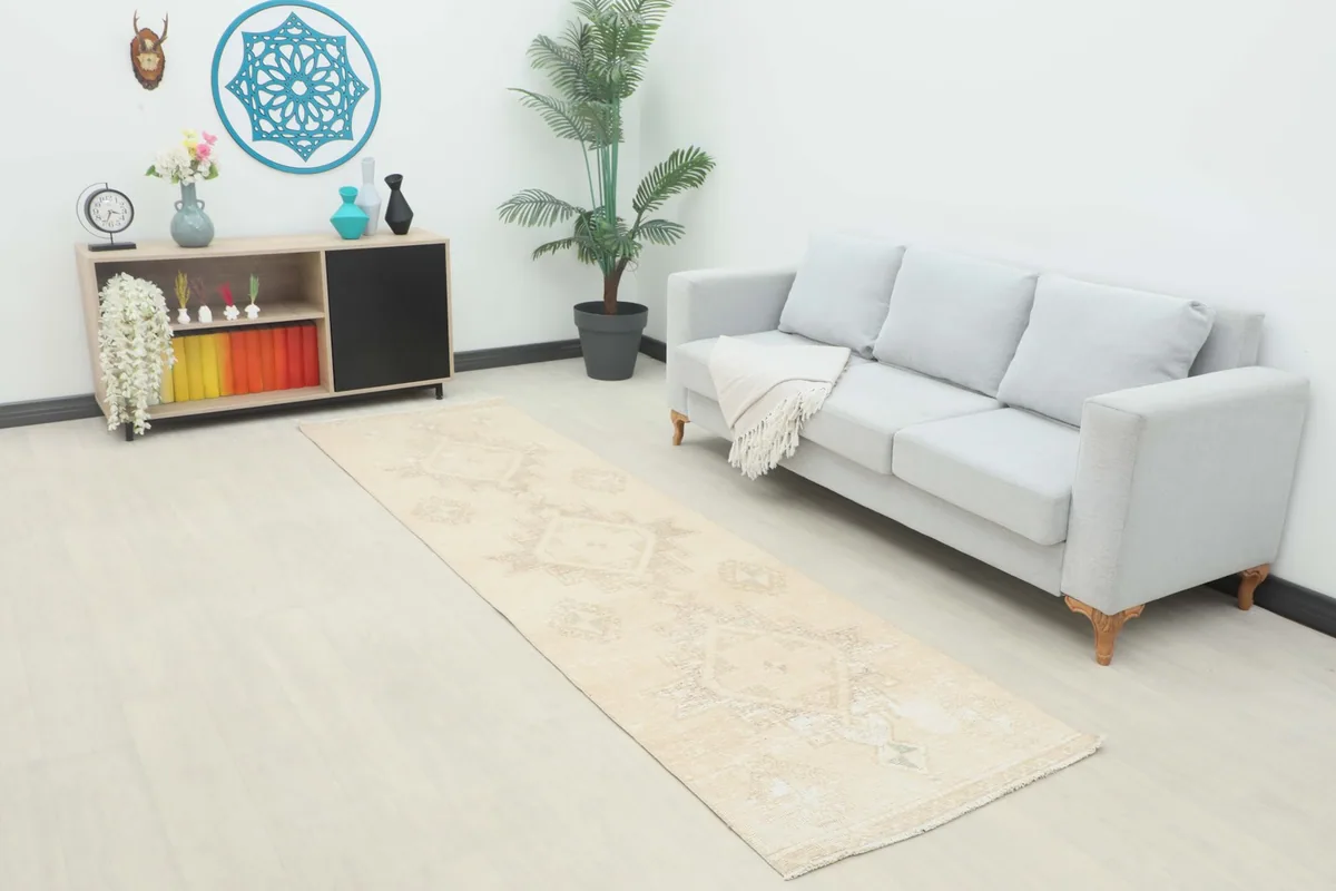 Ivory geometric runner rug displayed in a bright living room setup with a sofa